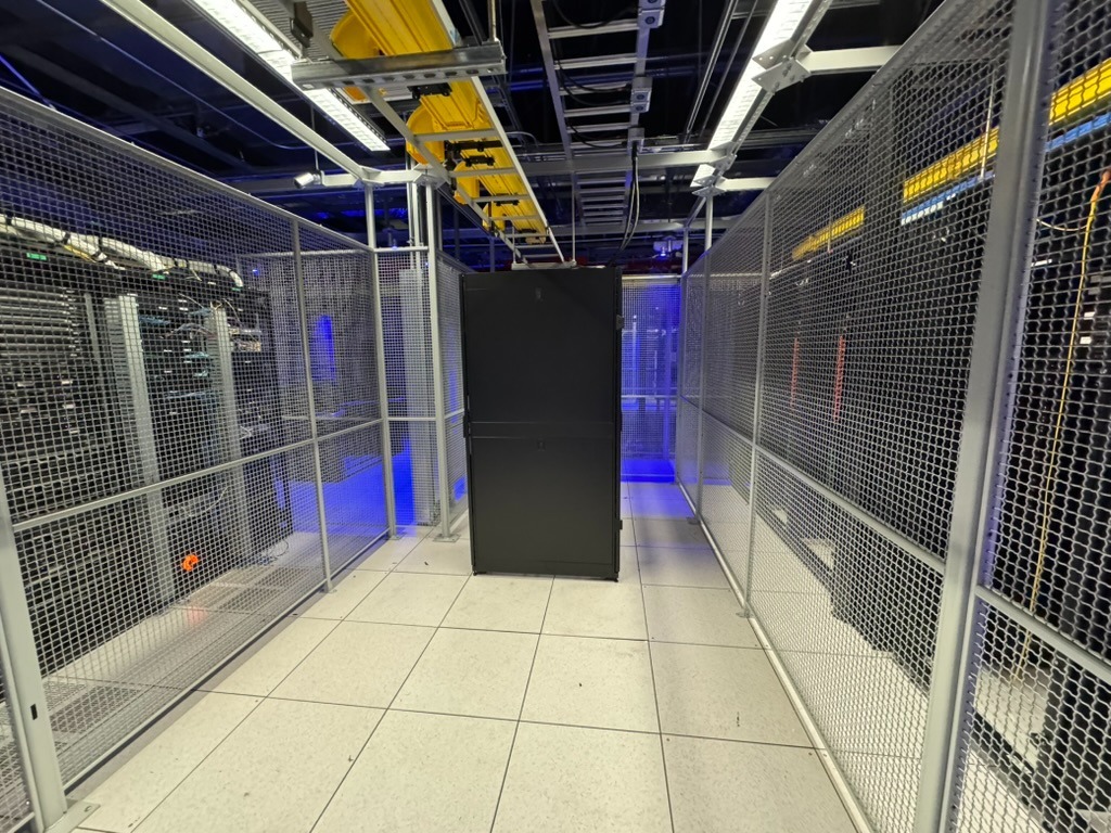 Equinix SV4 cage showing installed cabinet and overhead tray.